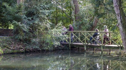 Visitors exploring the garden at Baddesley Clinton, Warwickshire